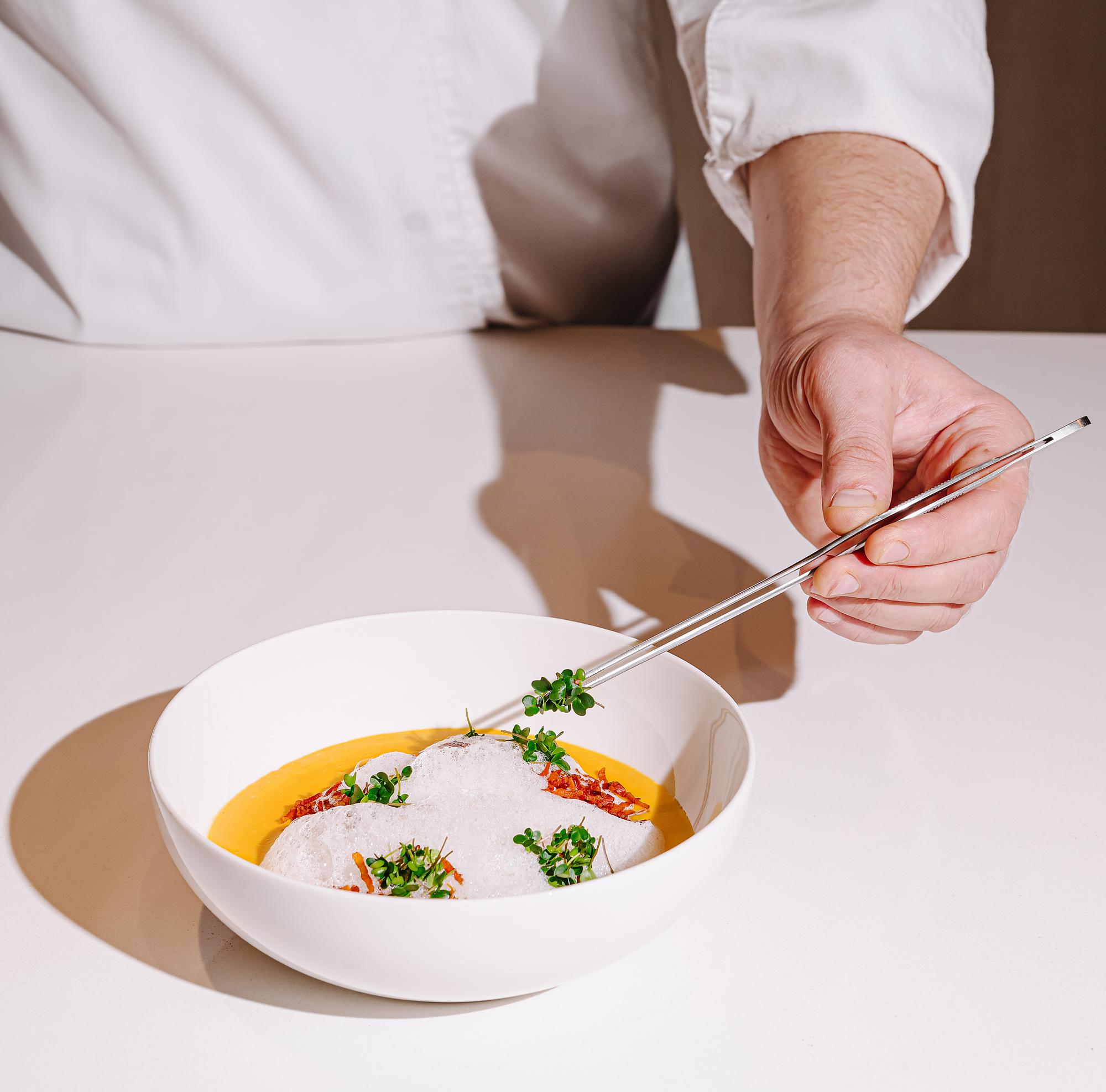 chef arranging plated quick meal on modern table